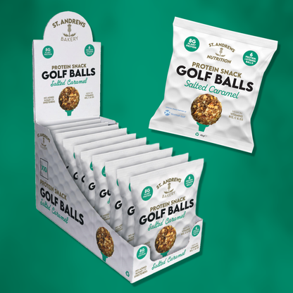 Display of St. Andrews Bakery Protein Snack Golf Balls packaging on a green background